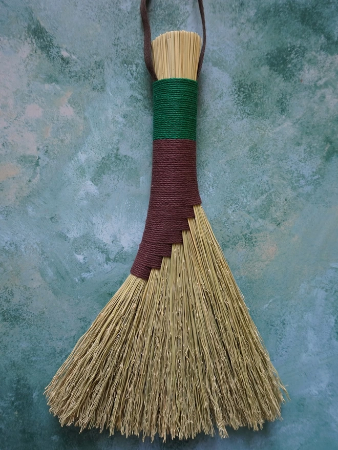 Handmade broomcorn brush with brown and green hemp cord binding