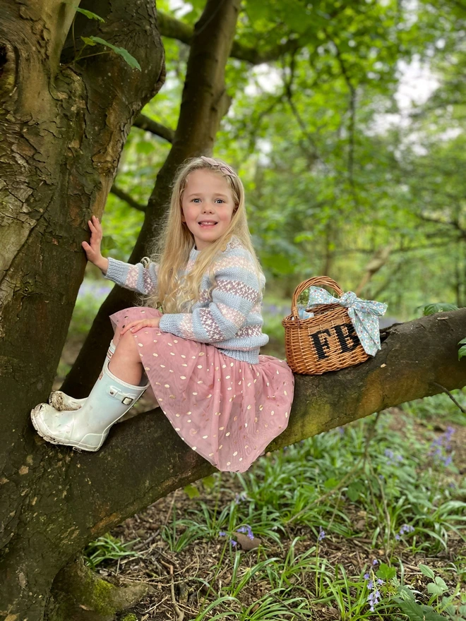 child posing on tree with personalised children's swing basket