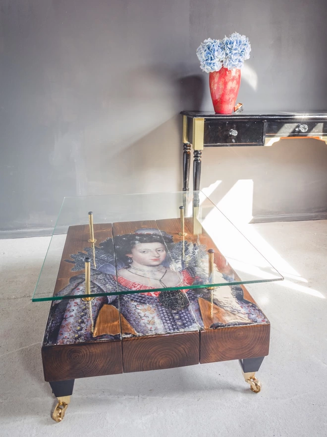 queen image on a dark brown wood coffee table