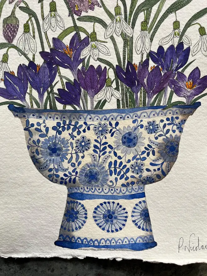 crocus, snowdrops and fritillary flowers in a blue and white, patterned ceramic vessel