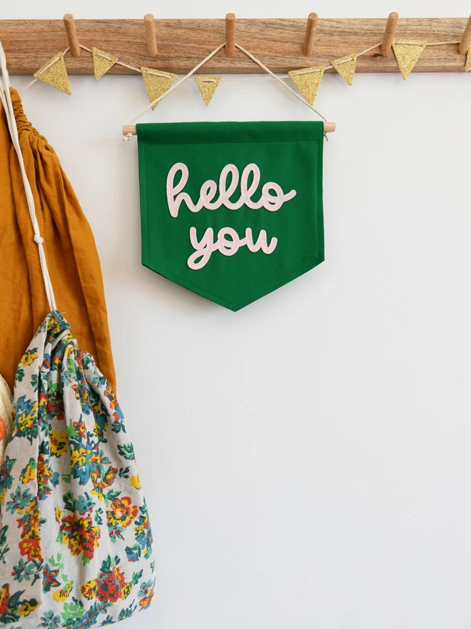 mini hello you felt wall banner for hanging in a hall way.