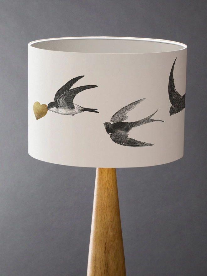 Drum Lampshade featuring Swallows with a white inner on a wooden base 