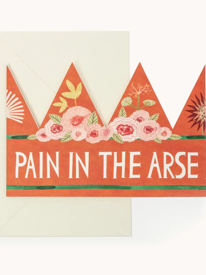 red crown shaped card with flowers and 'pain in the arse' text