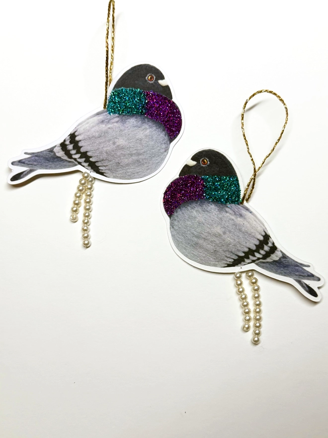 Pooping pigeon decorations with faux pearls and eco glitter on a plain white background 