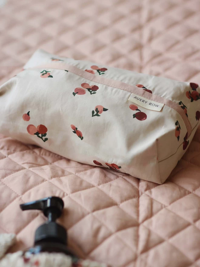 Baby wipes cover in peaches print with bath essentials