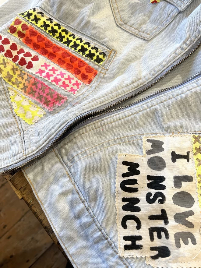 close up of patches saying I love monster munch on denim jacket