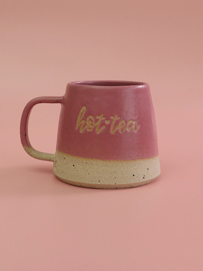 hot tea mug in fuchsia pink on a pink background 