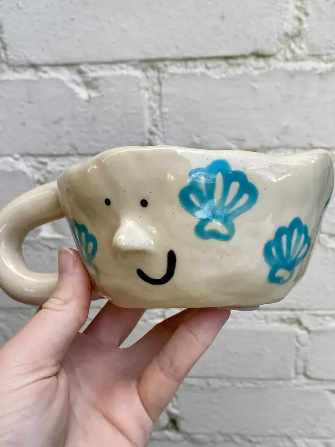 handmade ceramic smiley face shell mug