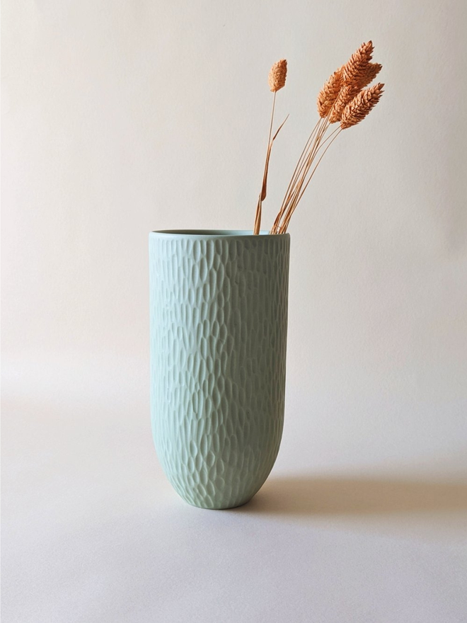 handmade textured pale blue vase with dried flowers