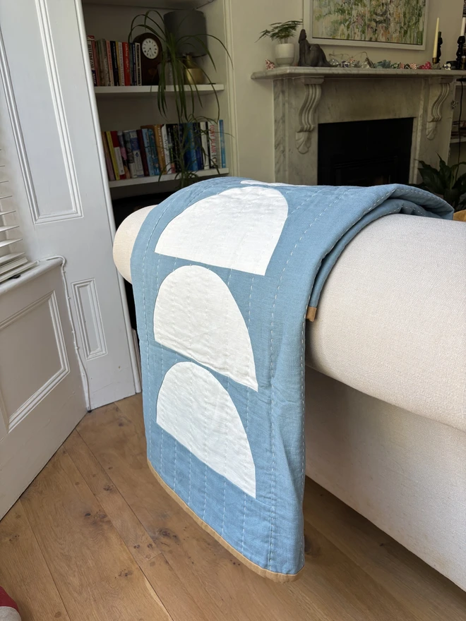 Wax & Wane Reversible Linen Throw Quilt. A blue and white geometric quilt.