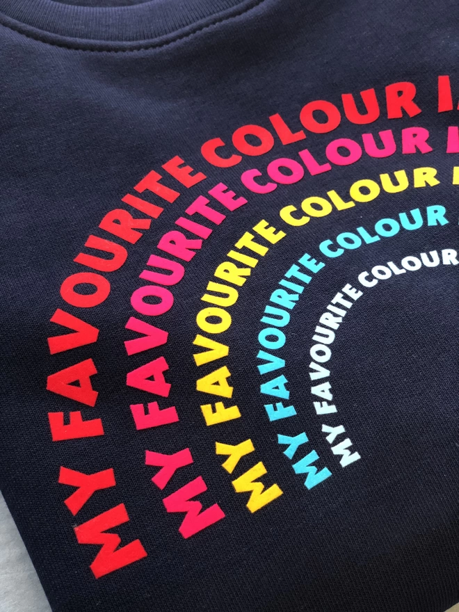 a 'Rainbow' Sweatshirt by The Faraway Gang with a rainbow on it.