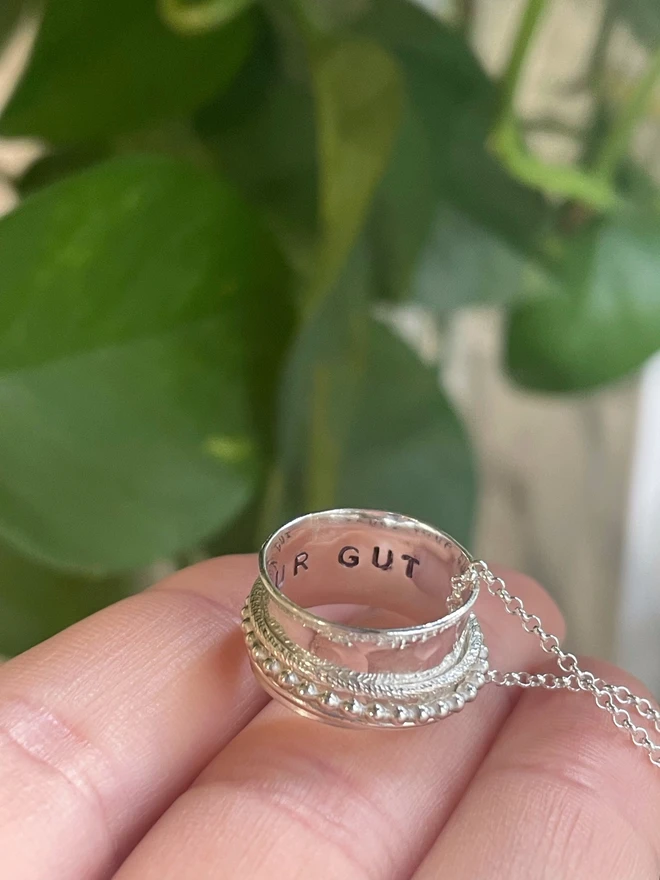 The 'Trust Your Gut' Spinner Pendant Necklace, gives you the reminder you need when the going gets tough. An adult fidget spinner to give you something tactile to do with your hands. This piece of jewellery is hand made from recycled sterling silver from a small business in the UK.