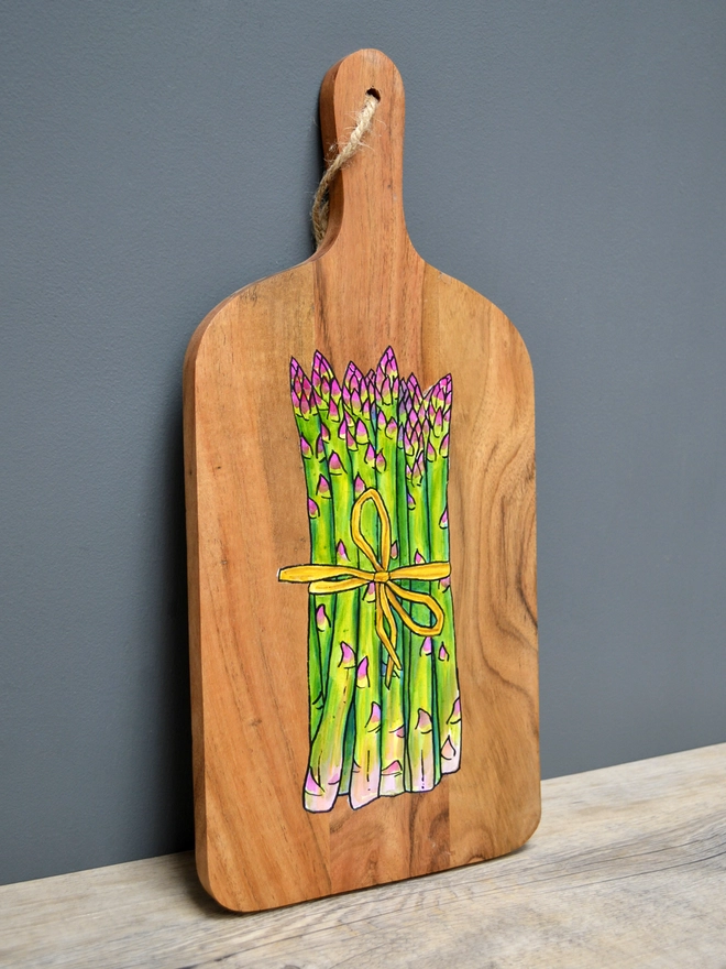 Wooden serving board with handpainted asparagus design