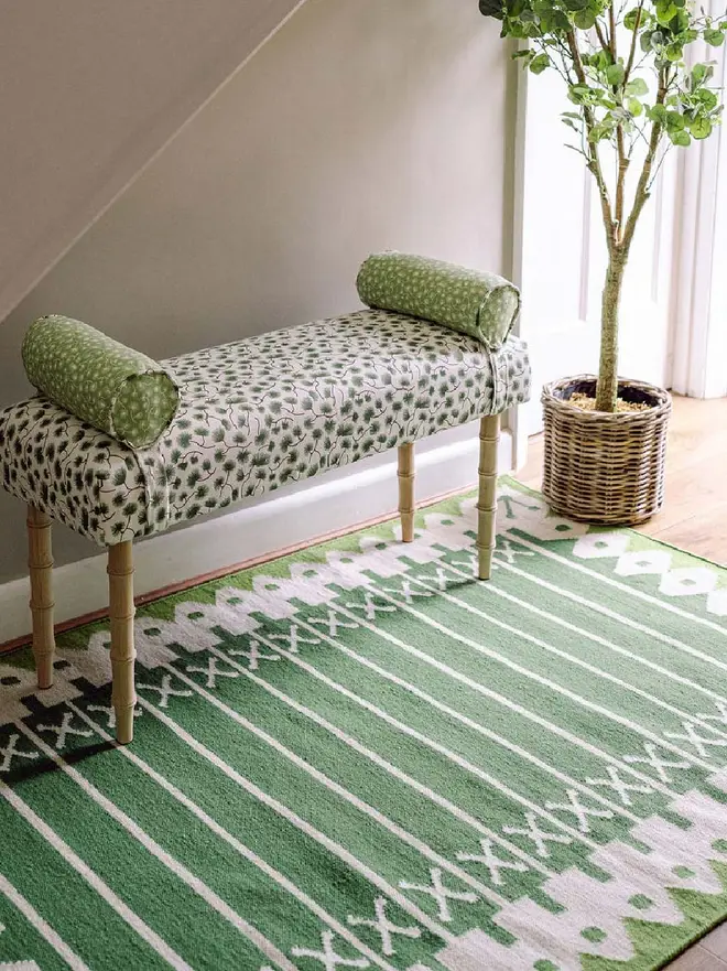 Darjeeling Flatweave Rug, a colourful rug in a living room. It is accompanied by other colourful furniture. 