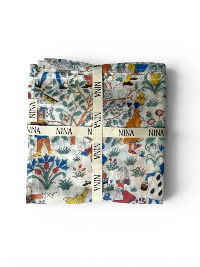 Alice in Wonderland Muslin. A muslin with an Alice in Wonderland themed design, folded.