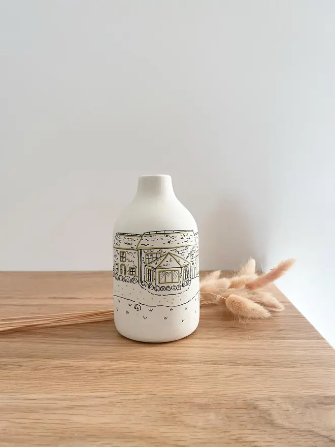 Custom Wedding Venue Hand Drawn Vase with dried flowers next to it  on a wooden table