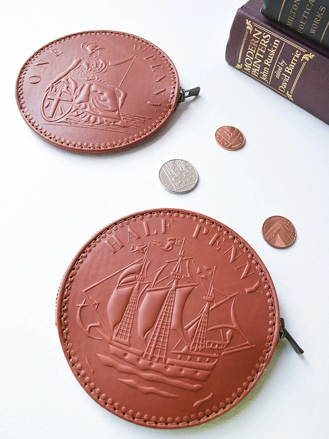 fun sized tan one penny and a half penny coin purse with loose change