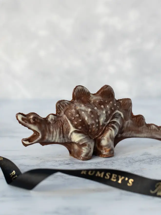 chocolate dinosaur. a marbled chocolate stegosaurus on a counter top.