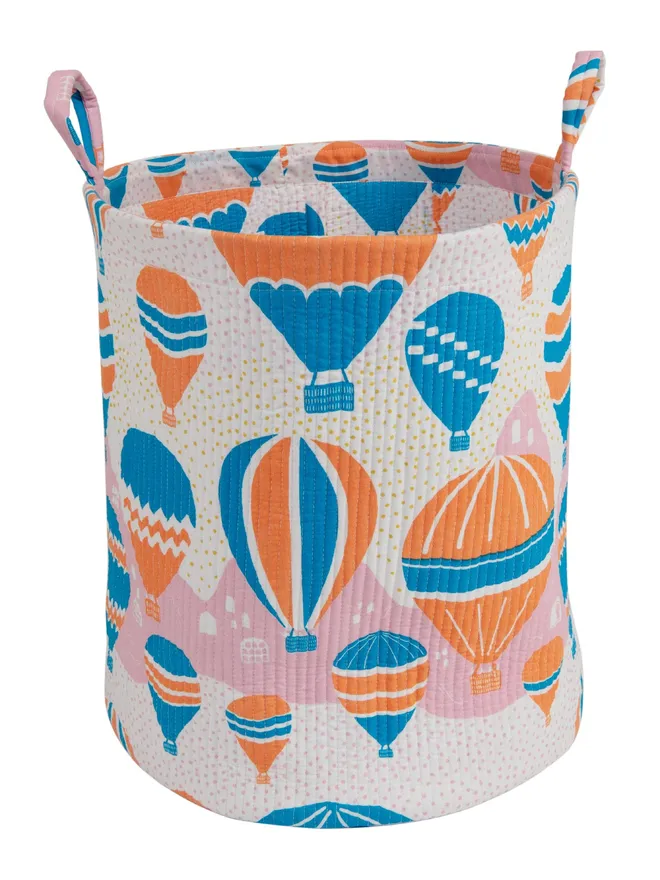 Balloons at Dawn Quilted Storage Basket, a hot air balloon print basket sitting against a white backdrop.