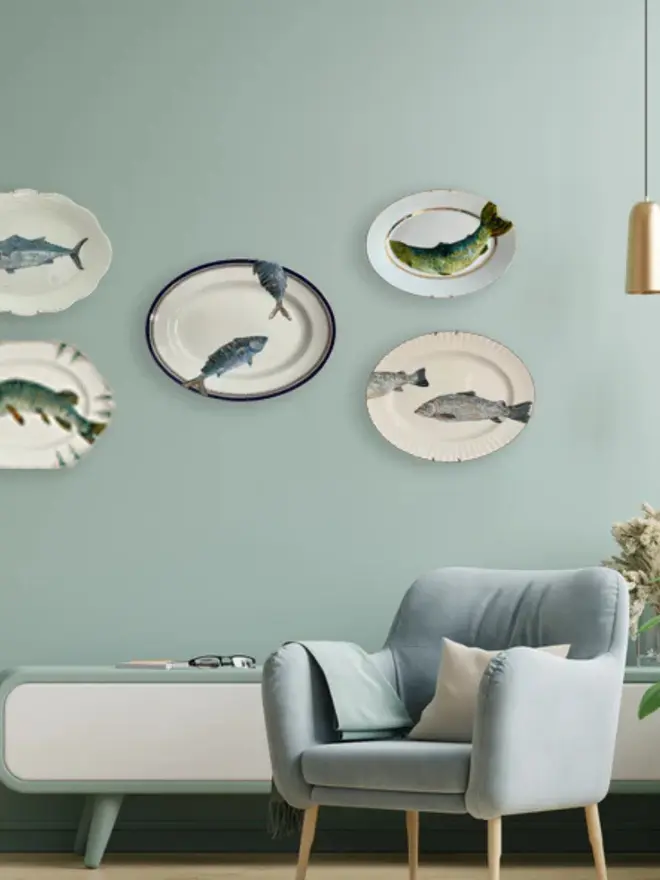 Plate-scape hanging on a blue wall. 