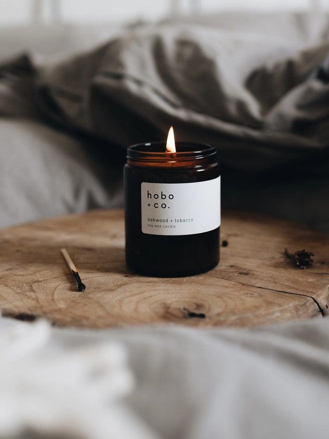 oakwood and tobacco medium jar candle lit looking cosy