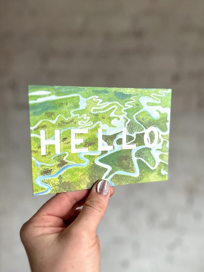 a greetings card featuring an illustration of some of the Everglades landscape with the text “hello”