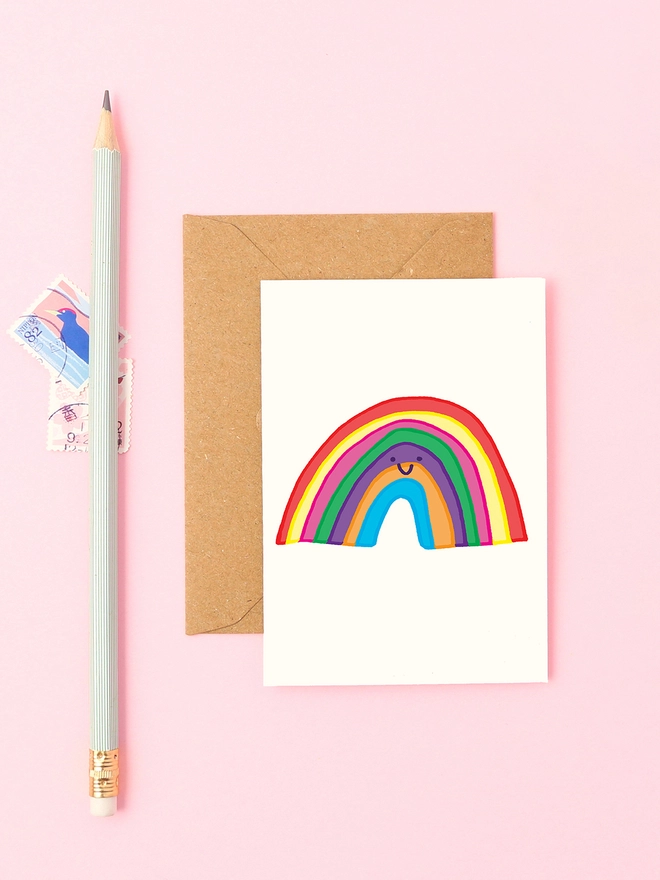 A bright and colorful hand-drawn rainbow with a smiley face, perfect for spreading positivity, sending encouragement, or celebrating Pride.