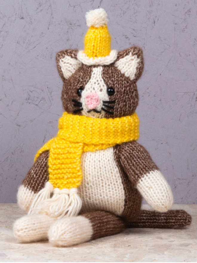 Cat in Knitwear Knitting Kit. A brown cat with yellow knitwear.