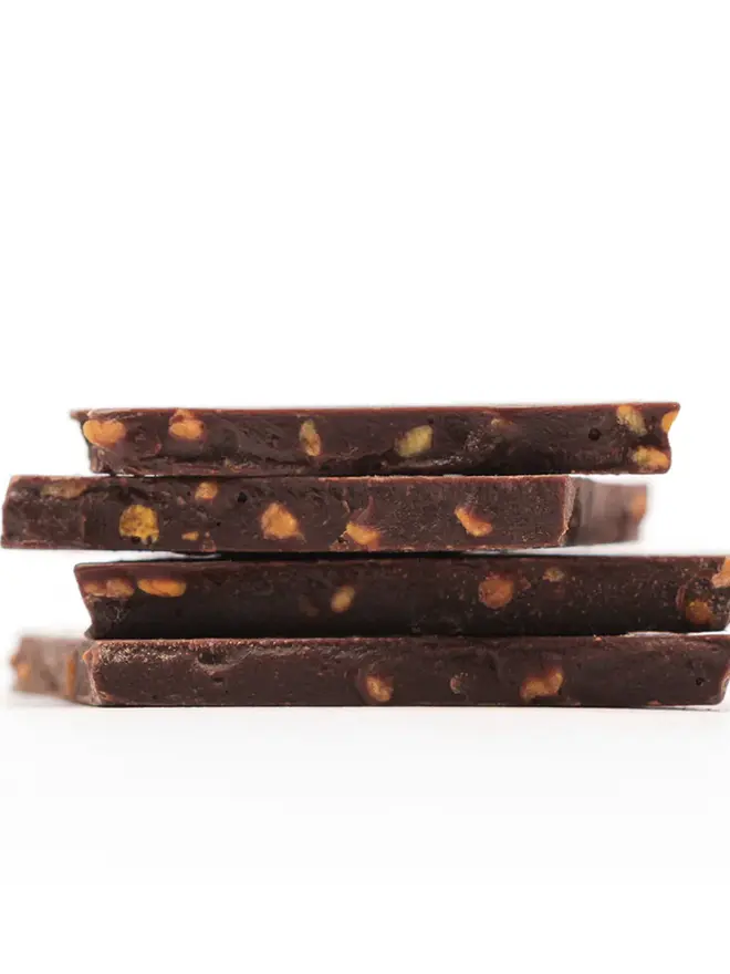 Cox&Co Sharing Shards Pouch - Bee Pollen & Honey, a collection of chocolate shards sitting on a white surface. 