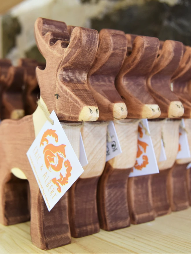 wooden reindeer toys stacked on shelves