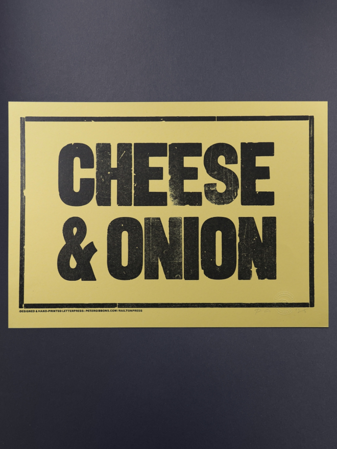 Cheese and Onion Print. A print with a yellow background and blocky black text.