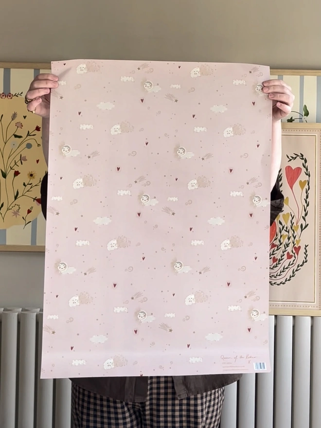 Always Forever Gift Wrap (3 Sheets), a person holding up the gift wrap indoors. 
