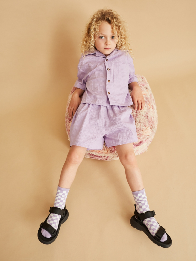 Boy looking very stylish in lilac shirt and short seersucker set for kids and toddlers by uk brand studio koter. also stocked at cissy wears, ando stores and word store in the uk, many stockists also in Japan