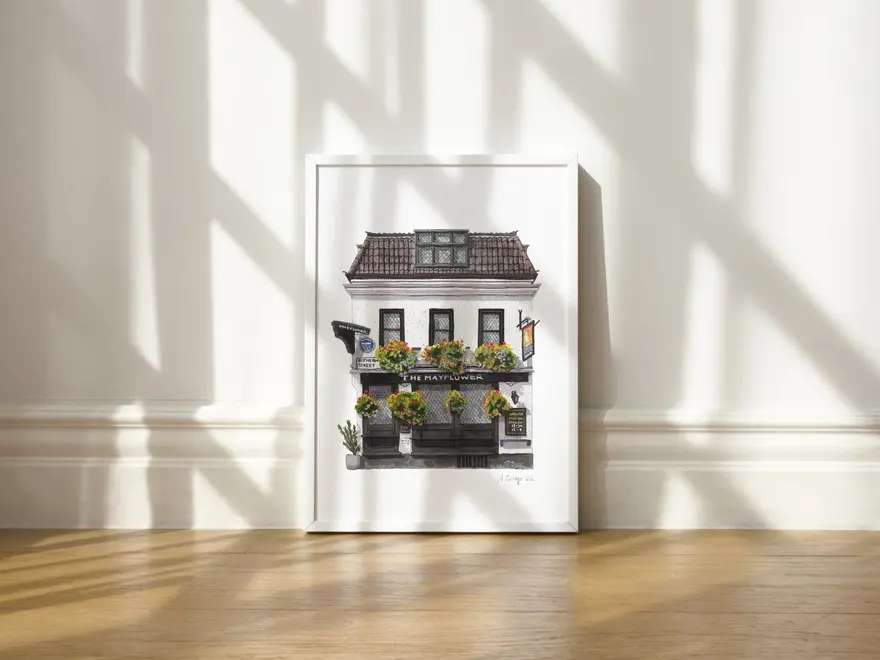 Rotherhithe The Mayflower Pub Giclée Print (Unframed), a print of a pub sitting in a white frame against a wooden surface against a plain backdrop. 