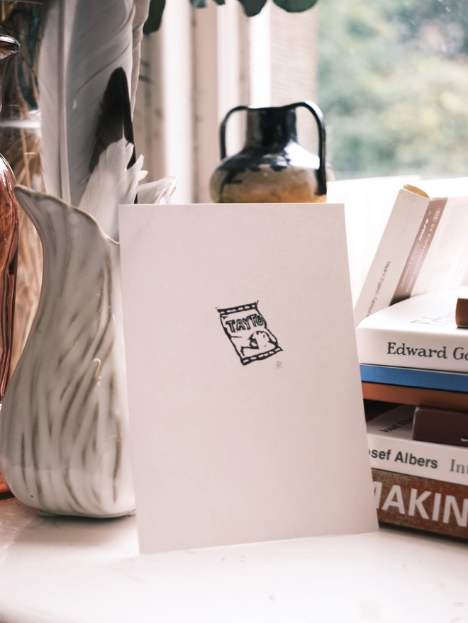 a white page showing a tiny tayto crips packet linoprint 