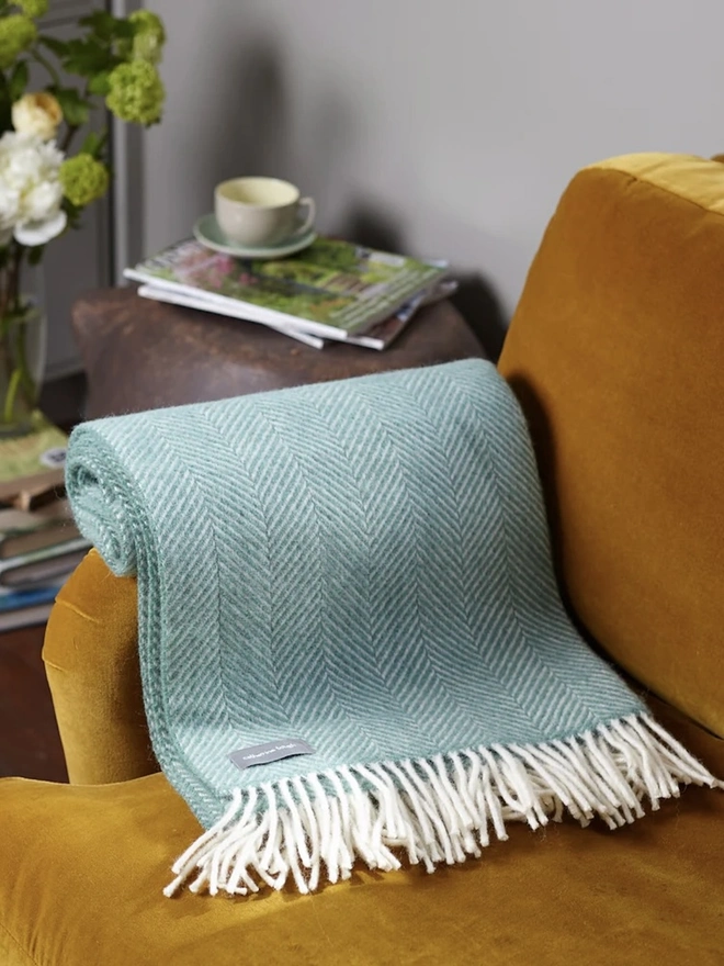 Organic Wool Throw, an organic wool throw sitting on a sofa. 