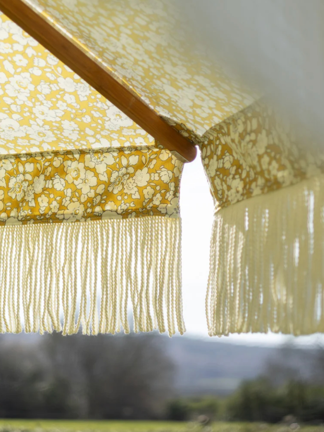 Liberty London Fringed Parasol. A parasol in fennel yellow.