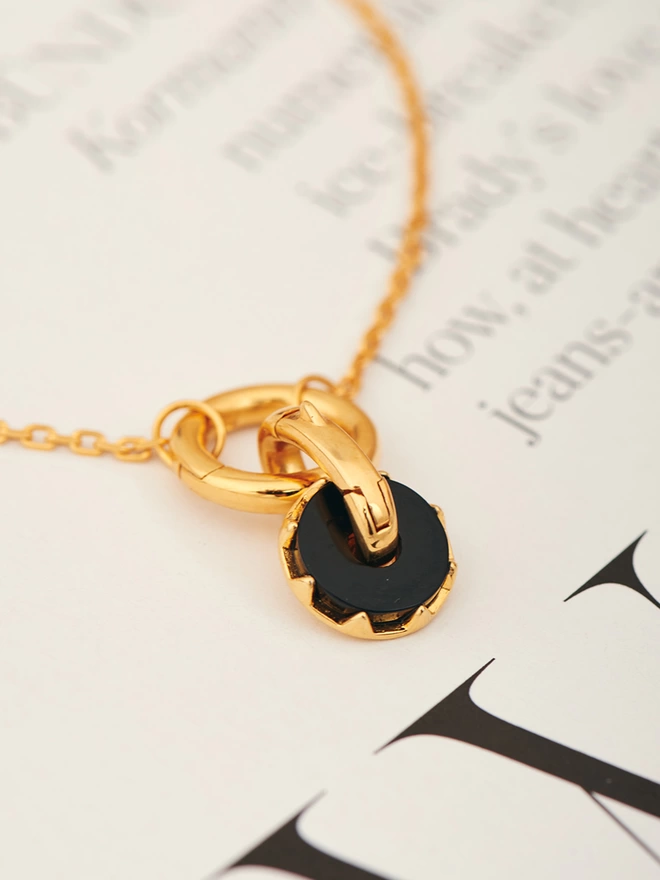 black onyx charm on gold bracelet