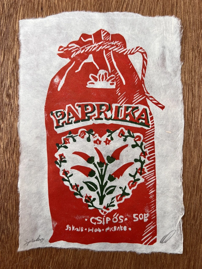 paprika spice bag lino print on natural handmade paper, featuring a detailed vintage-style paprika bag illustration.