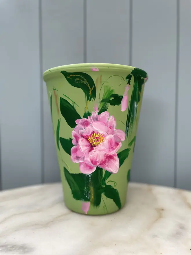 terracotta plant pot hand painted floral terracotta plant pot green background with pink peony flowers.