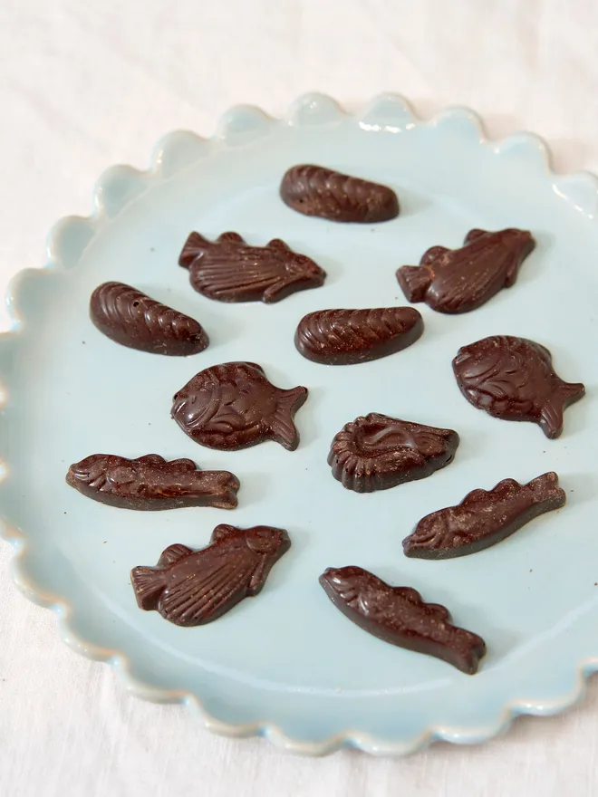 dark chocolate sea creatures on blue plate