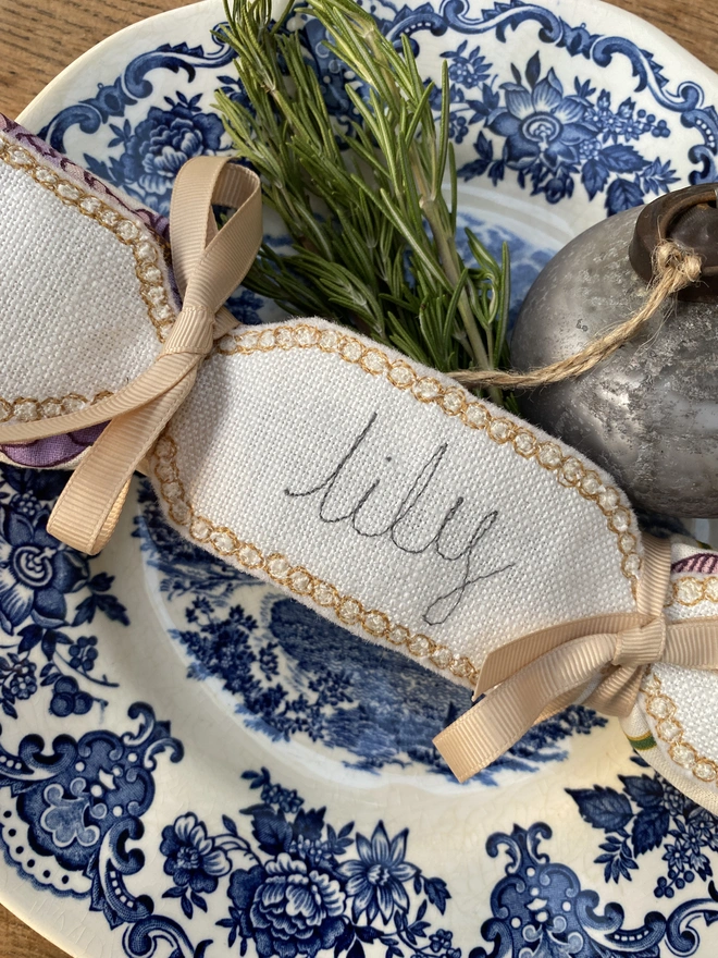 Fabric Cracker Napkin Decoration on blue pattern plate with bauble