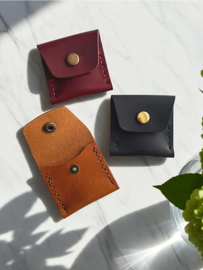 Coin purses in tan, red and navy