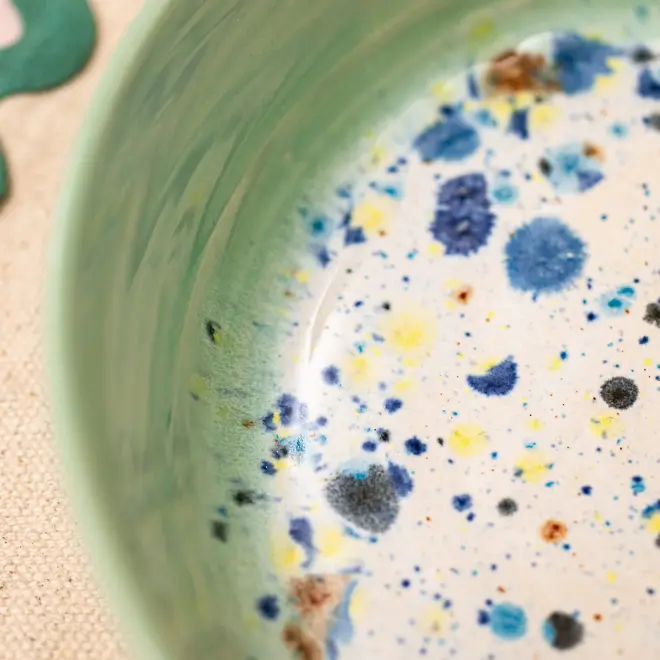 Shoreline Ramen Bowl, a close up of a colourful ramen bowl placed on a table setting. 