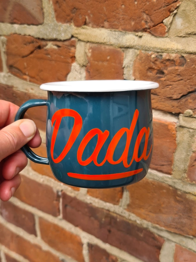 Green mug with orange text