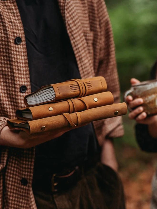  leather refillable ring binder. a stack of light brown ring binders.