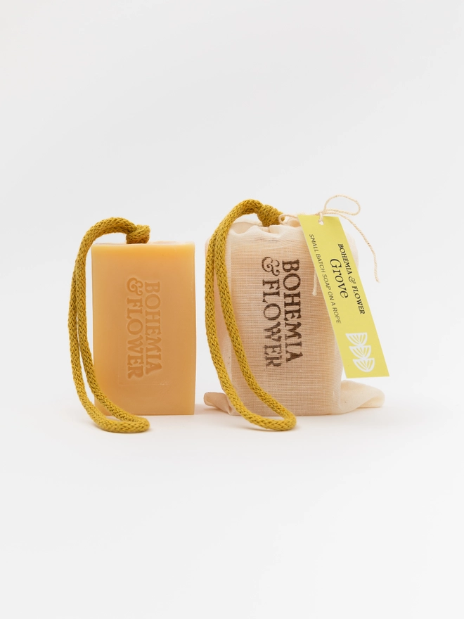 Grove Soap on a Rope with packaging and unpackaged bar – handmade yellow citrus soap with orange, bergamot, and calendula petals by Bohemia & Flower