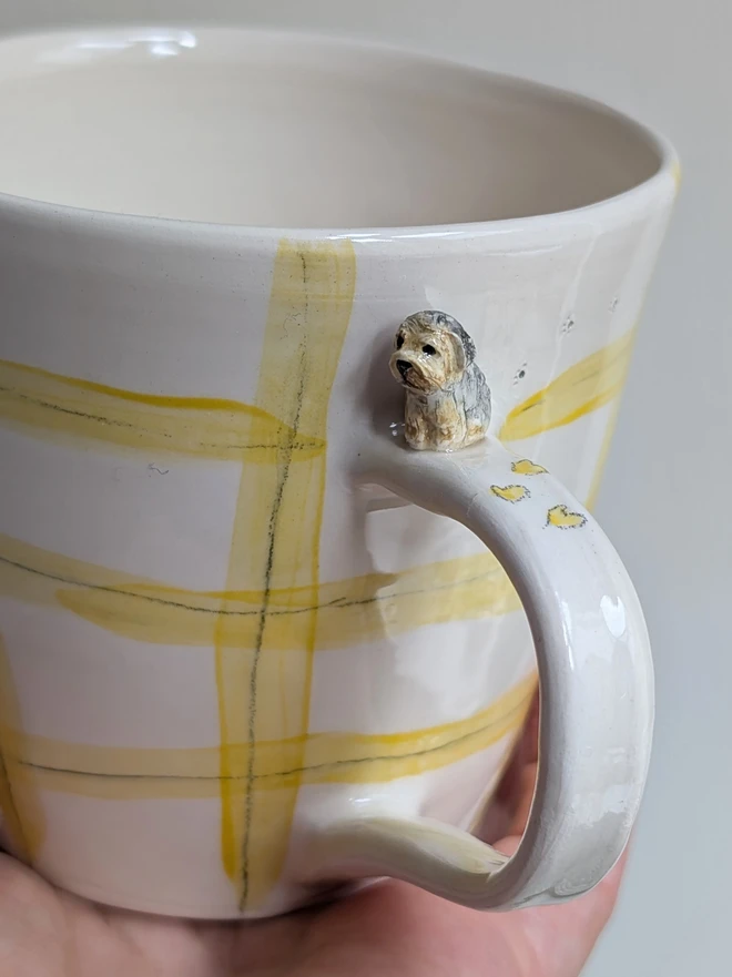 yellow check handmade dog mug with a miniature yorkie yorkshire terrier sitting on the handle this hearts and tiny paw prints on the cup