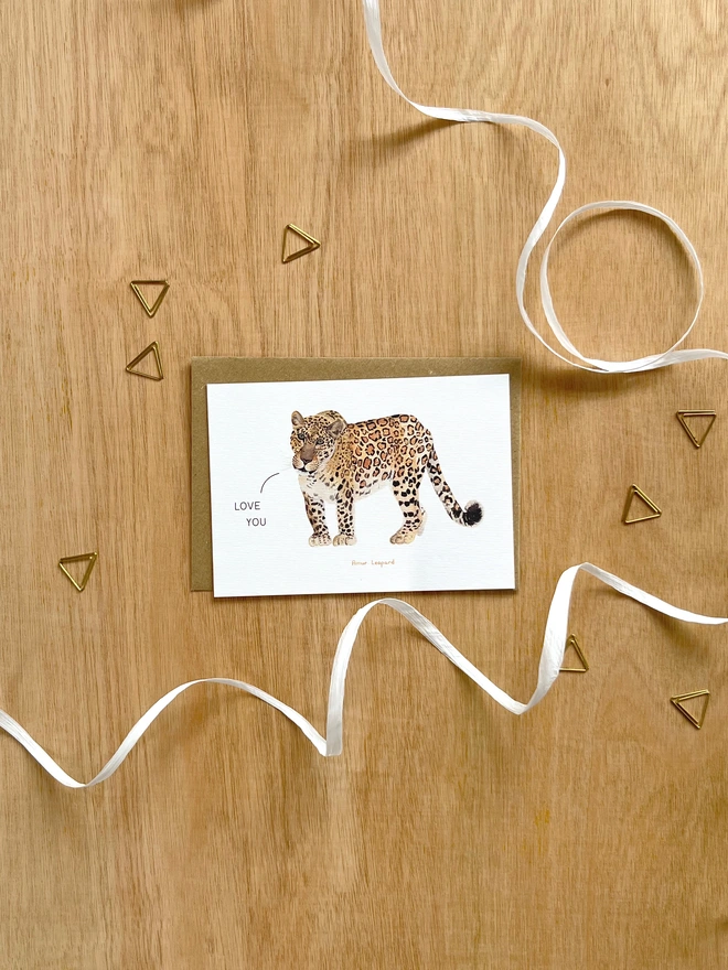 a greetings card featuring an illustration of a leopard with the text “love you”