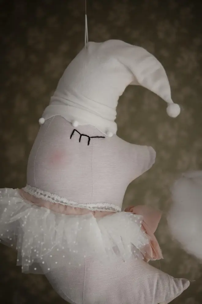 Sleepy Moon Nursery Pillow Hanging Decoration, a hanging pillow decoration suspended in a bedroom. 